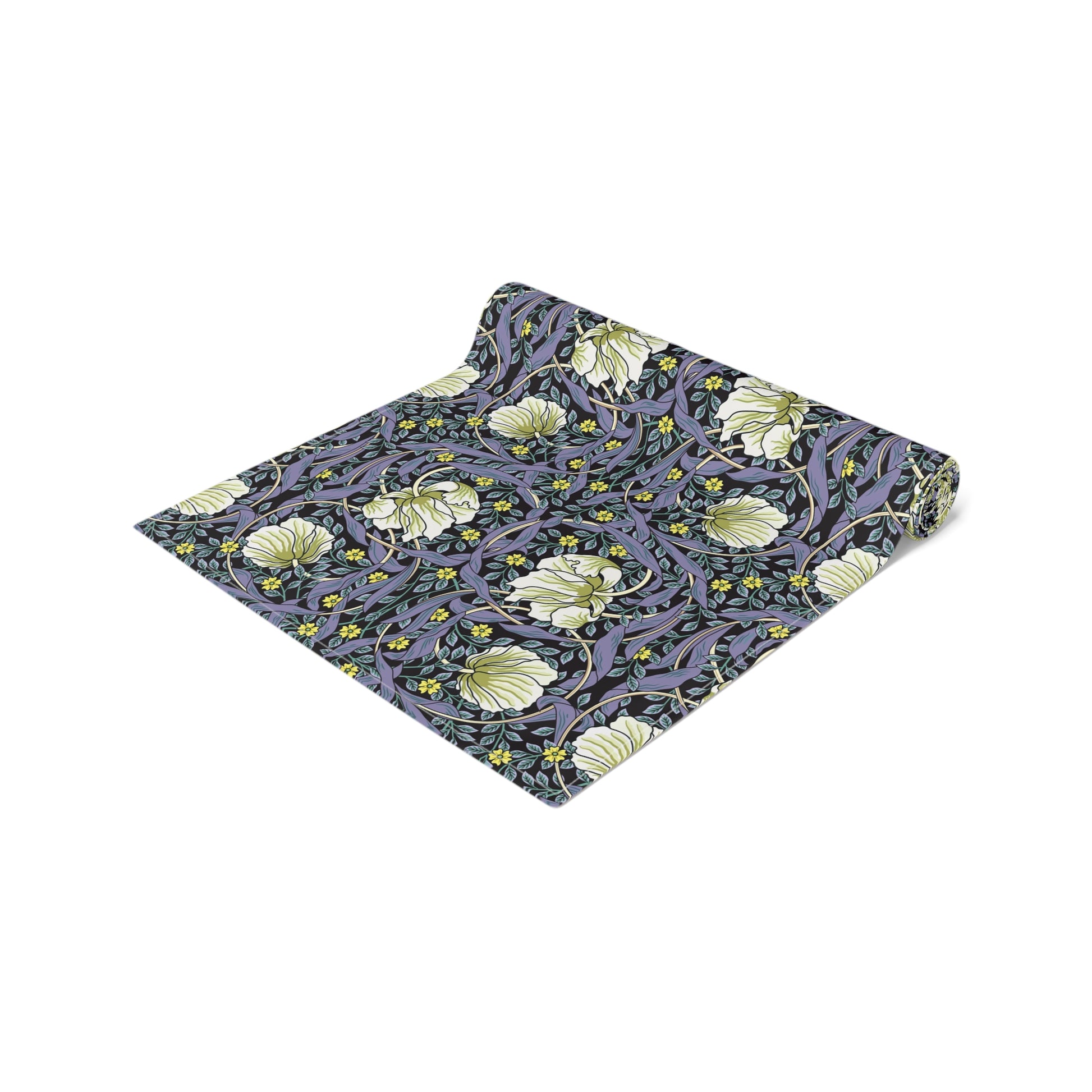 A table runner with a floral William Morris & Co pattern in shades of purple and green laid out on a dining table.