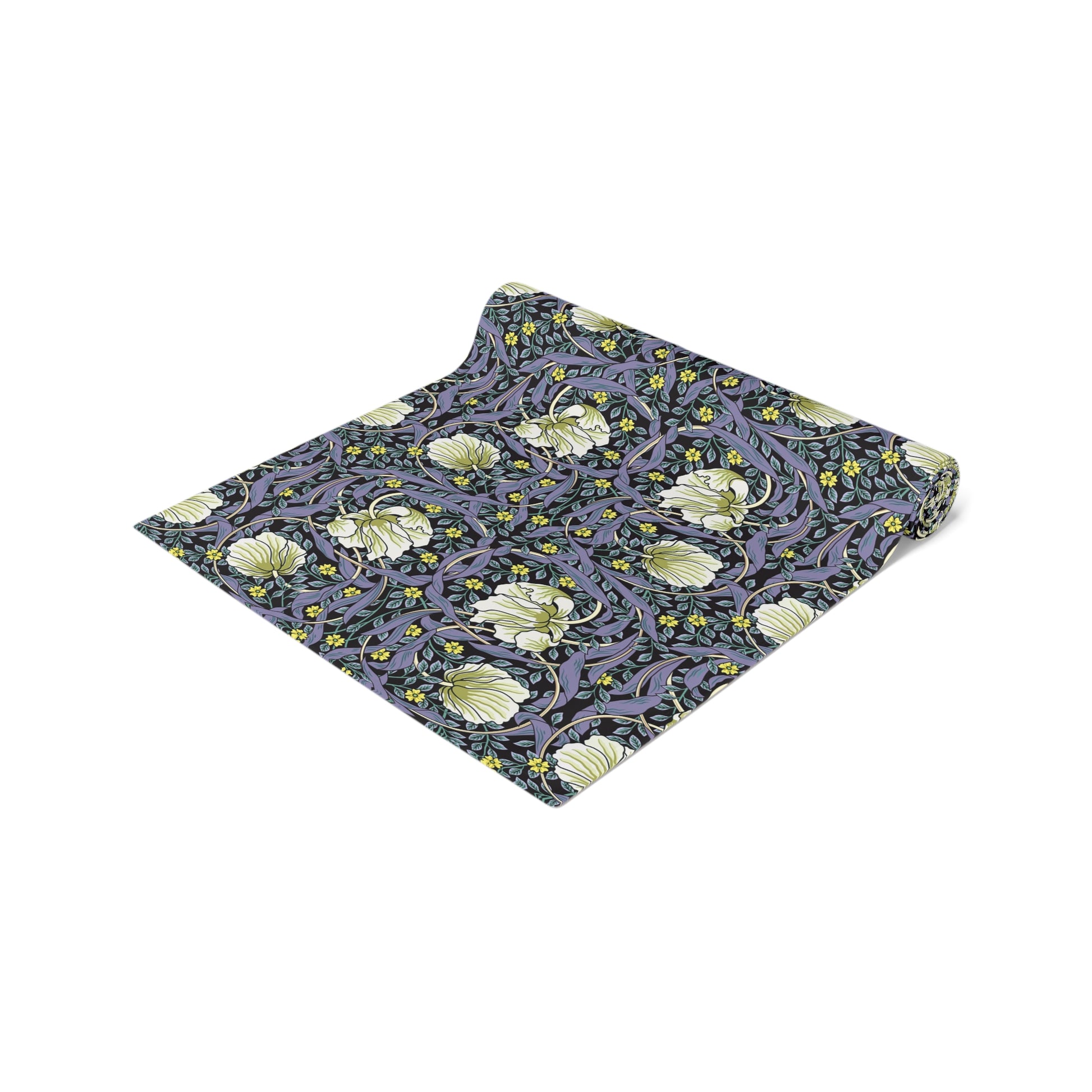A table runner with a floral William Morris & Co pattern in shades of purple and green laid out on a dining table.