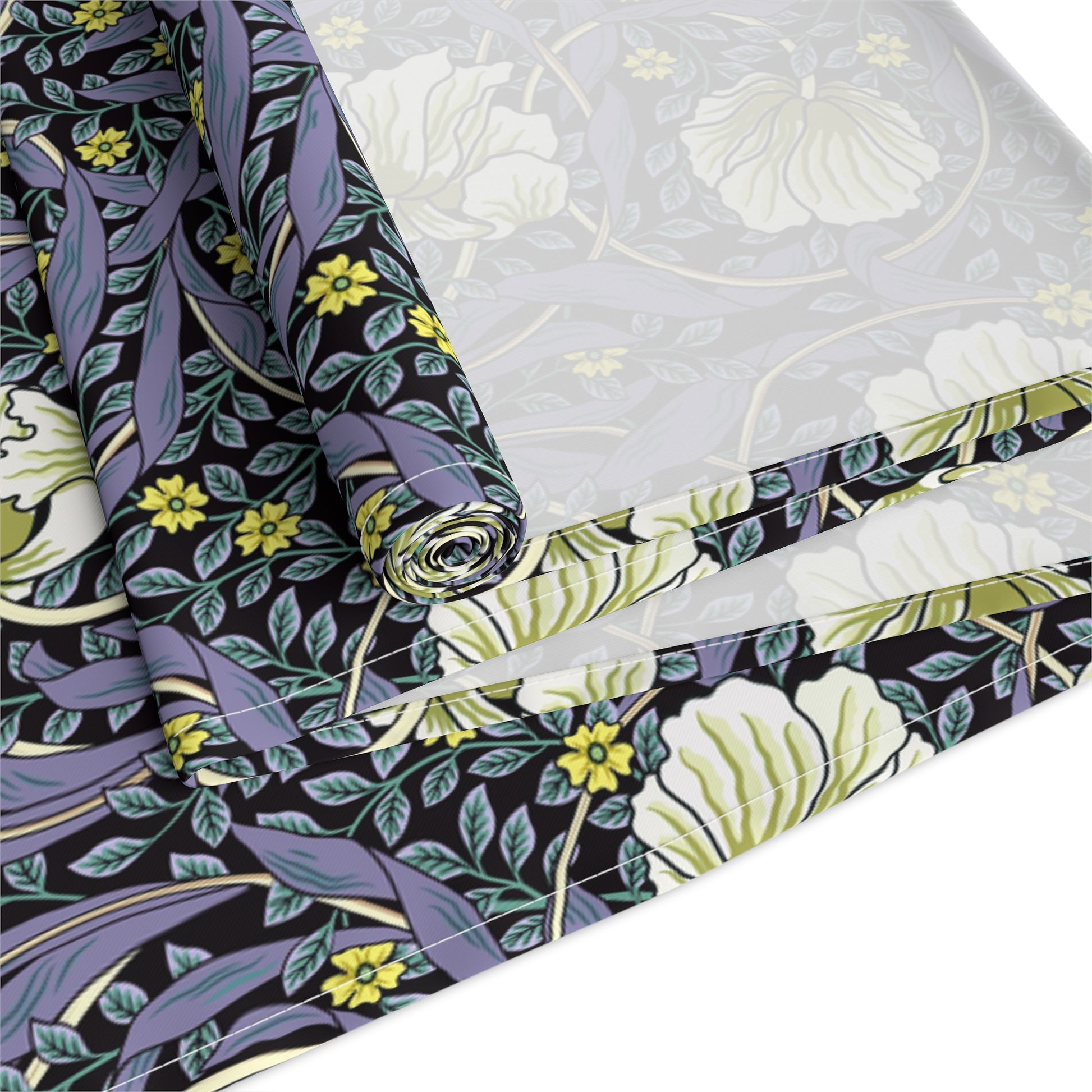 A table runner with a floral William Morris & Co pattern in shades of purple and green laid out on a dining table.