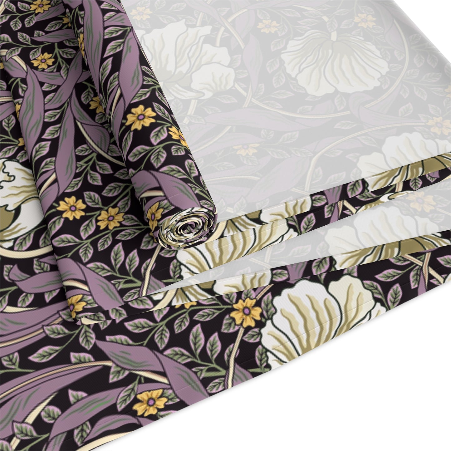 A table runner with a floral William Morris & Co pattern in purple, gold, and green colours, laid out on a dining table.