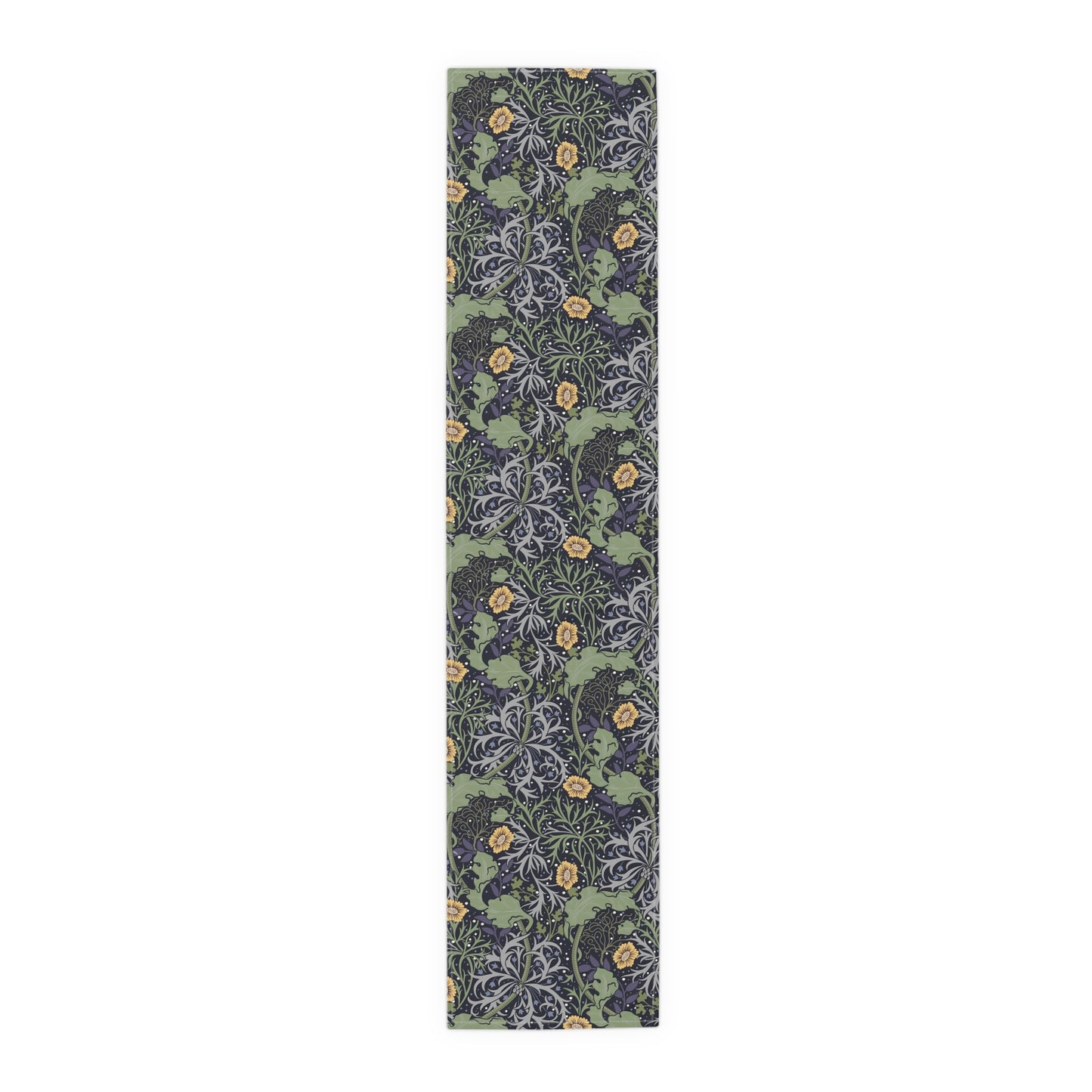 A table runner with a floral William Morris & Co pattern in yellow and green shades displayed on a dining table.