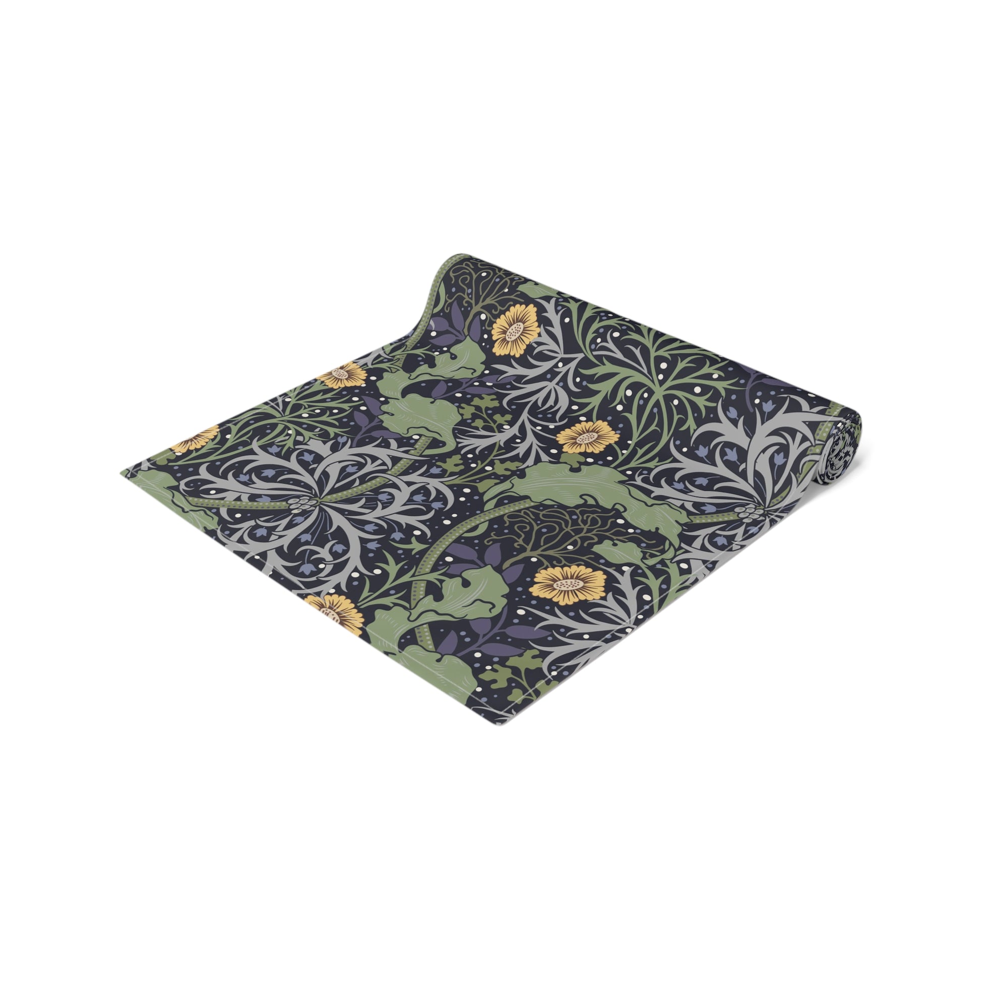 A table runner with a floral William Morris & Co pattern in yellow and green shades displayed on a dining table.