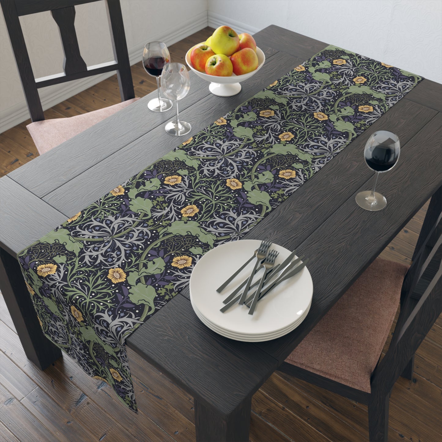A table runner with a floral William Morris & Co pattern in yellow and green shades displayed on a dining table.