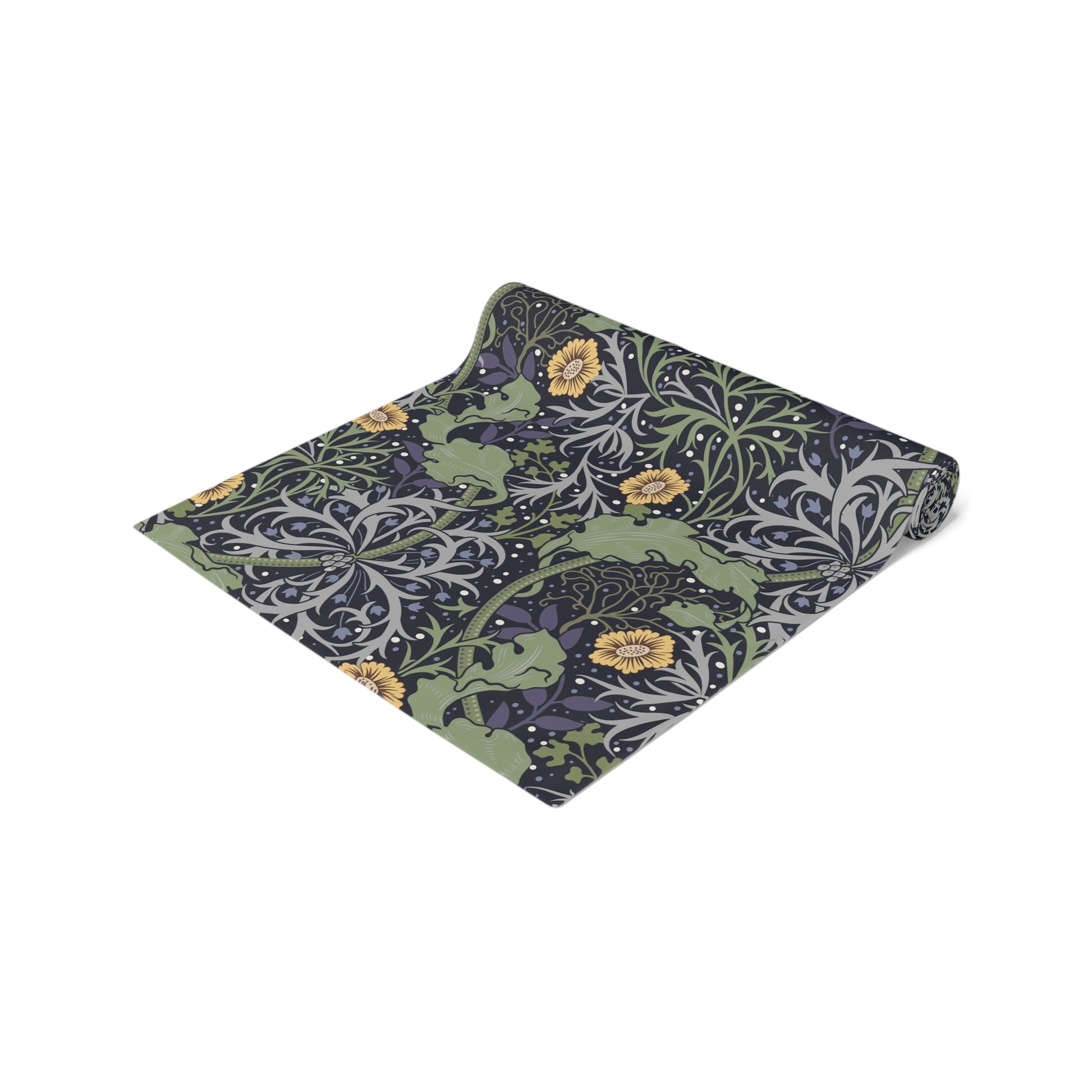 A table runner with a floral William Morris & Co pattern in yellow and green shades displayed on a dining table.
