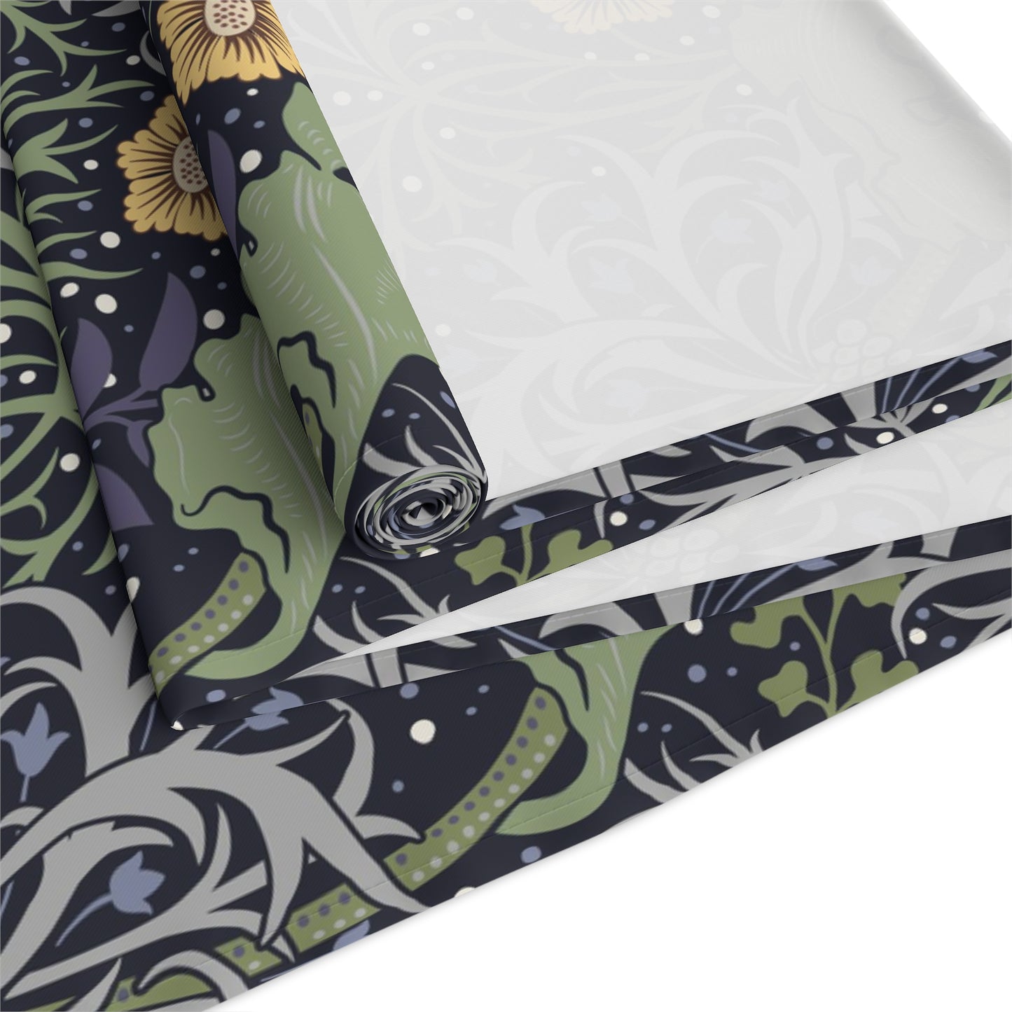 A table runner with a floral William Morris & Co pattern in yellow and green shades displayed on a dining table.