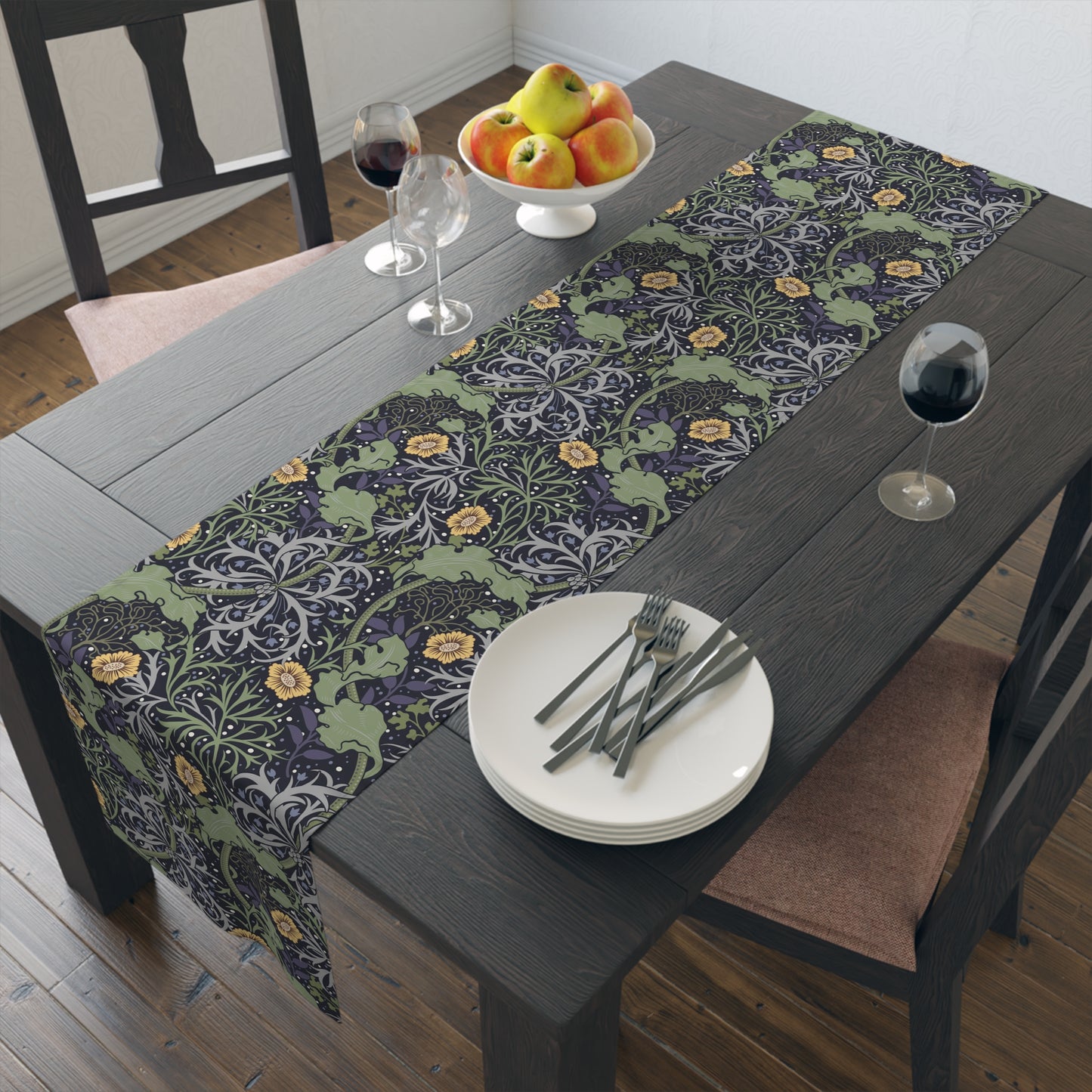 A table runner with a floral William Morris & Co pattern in yellow and green shades displayed on a dining table.