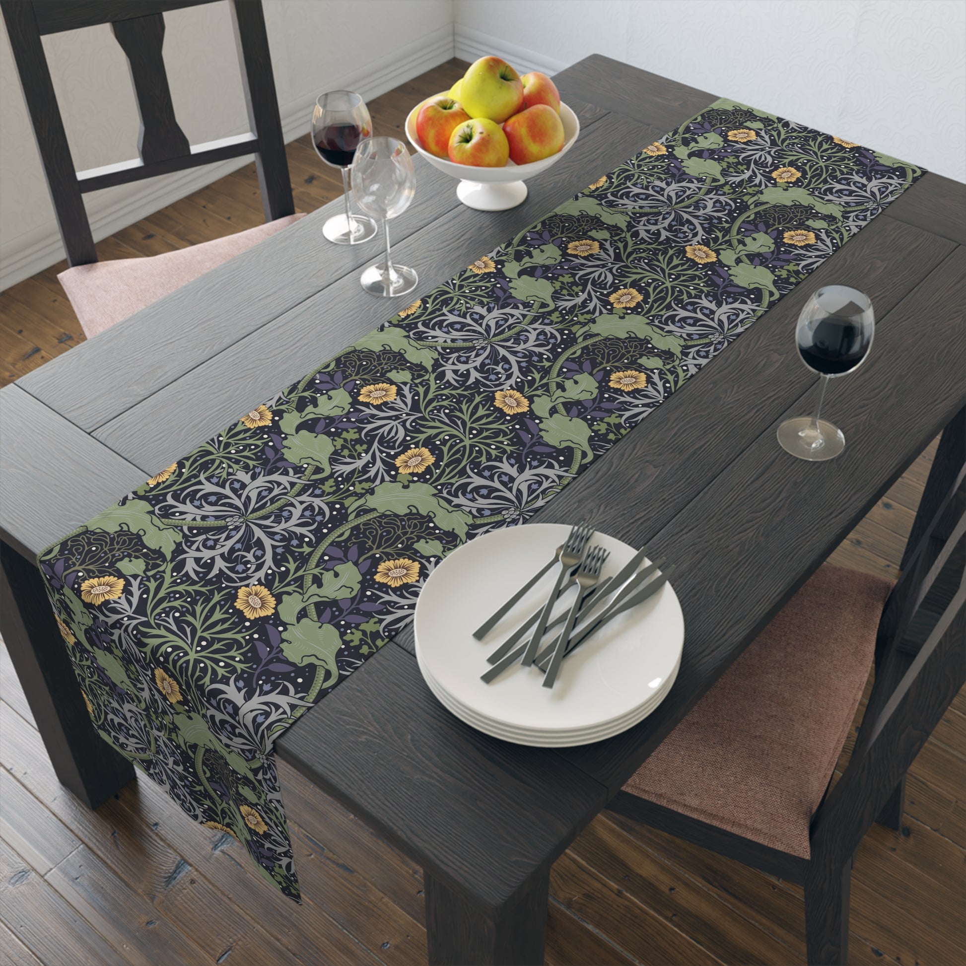 A table runner with a floral William Morris & Co pattern in yellow and green shades displayed on a dining table.