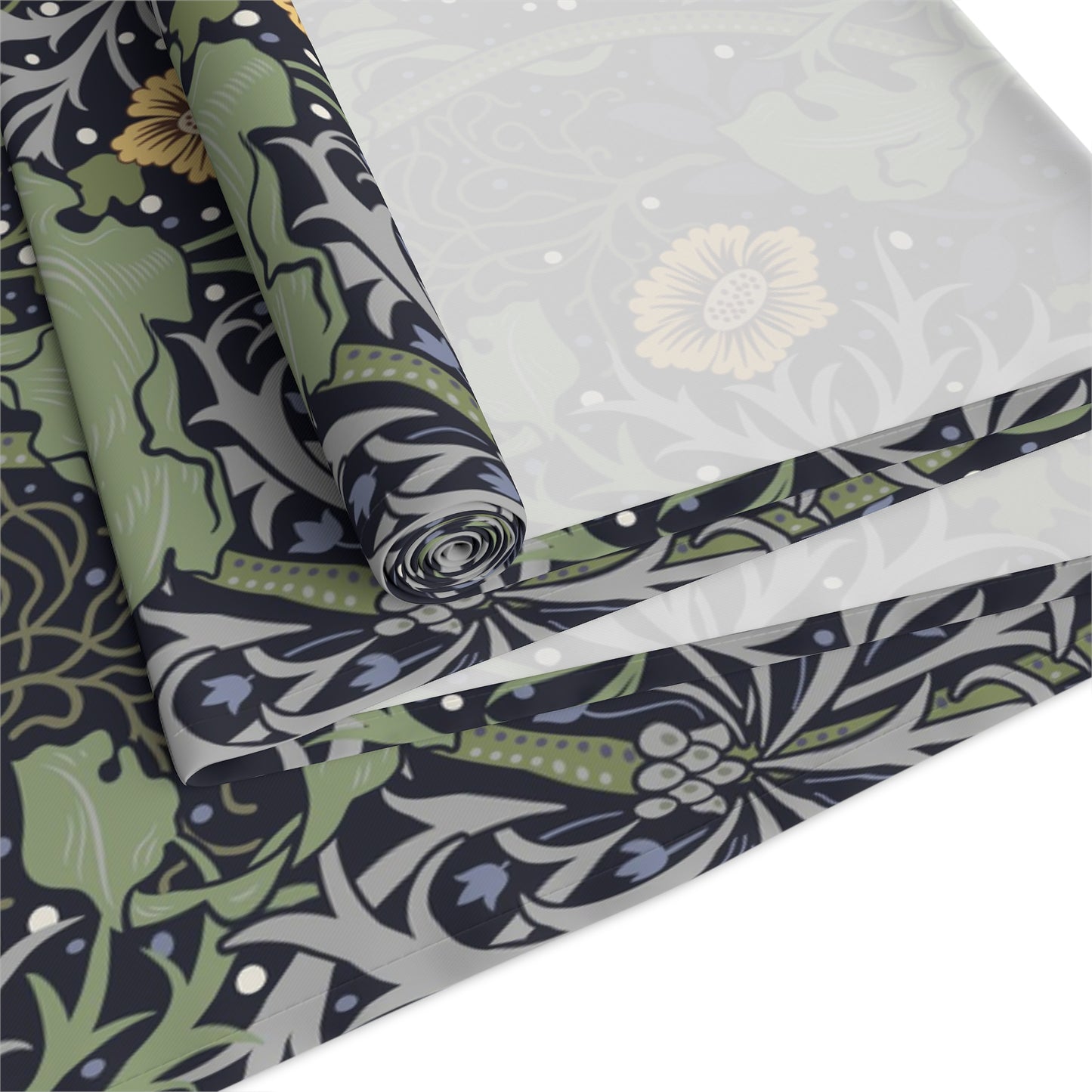 A table runner with a floral William Morris & Co pattern in yellow and green shades displayed on a dining table.