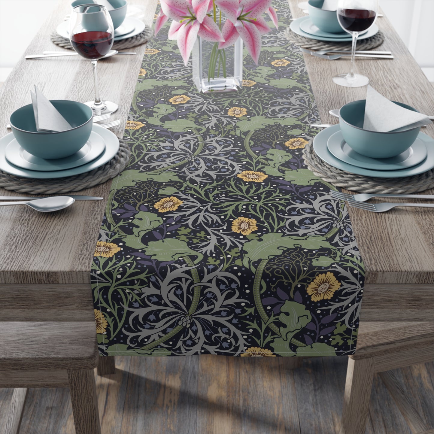 A table runner with a floral pattern in yellow and green shades displayed on a dining table.