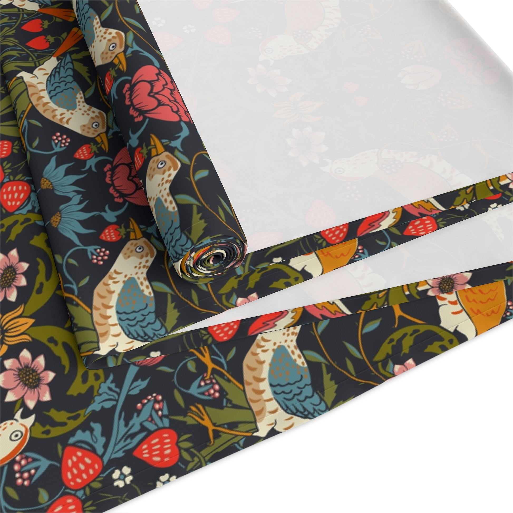 Roll of decorative wrapping paper with birds and flowers on a dark background.