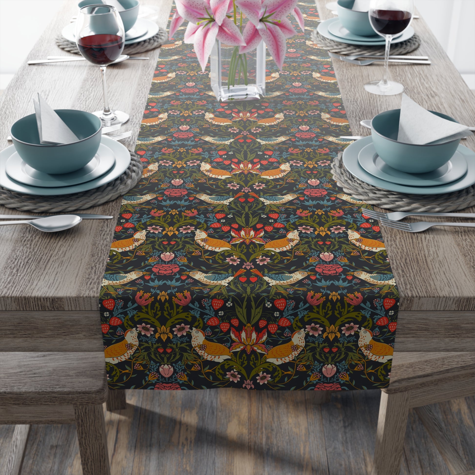 Dining table with a colorful floral table runner and blue ceramicware.