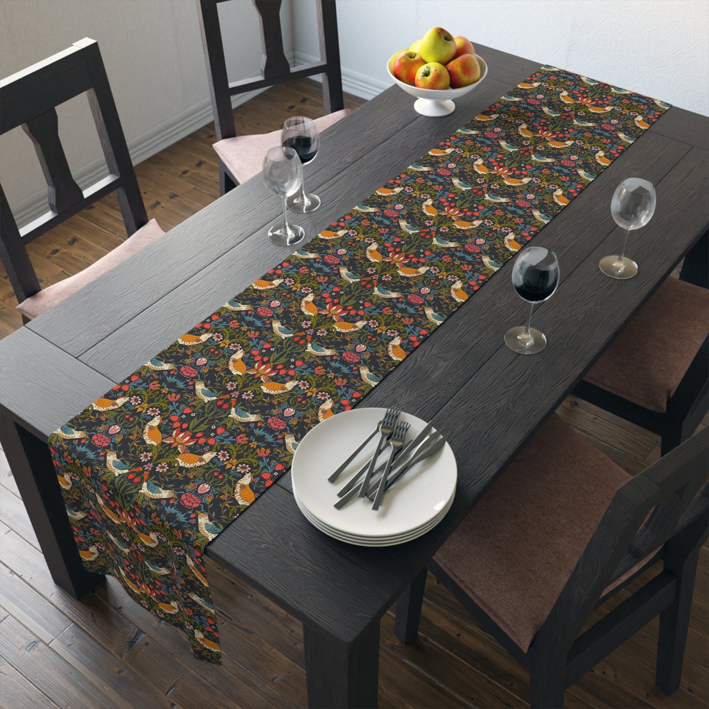 Dining table with floral table runner and place settings.