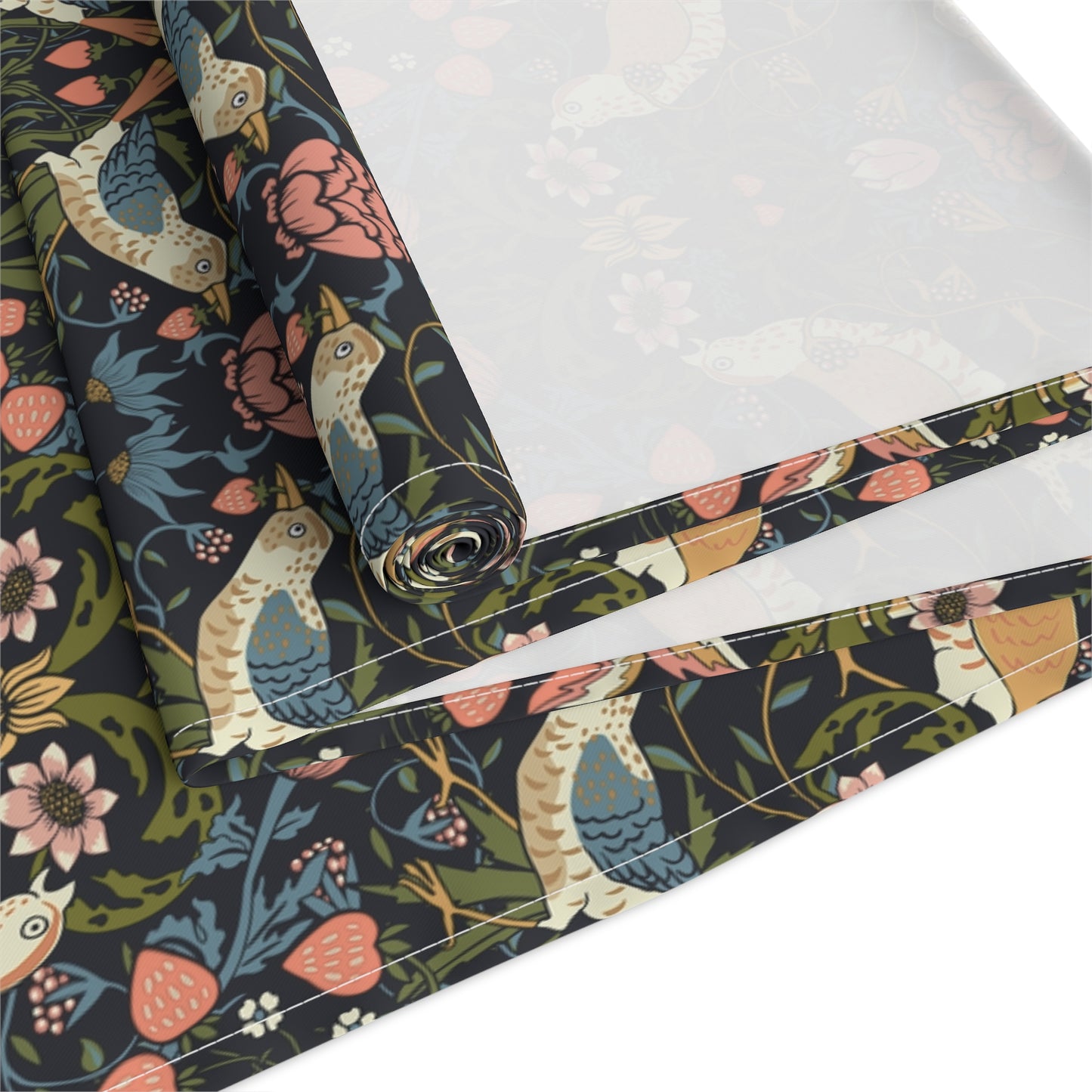 Roll of fabric with floral and bird pattern on a white background