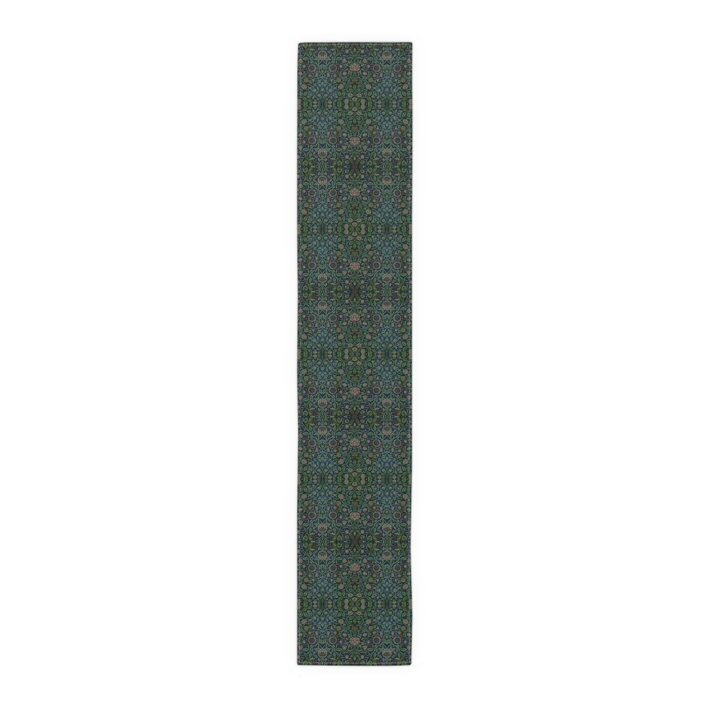A green floral patterned table runner inspired by William Morris, laid out on a wooden dining table with plates and cutlery set on top.