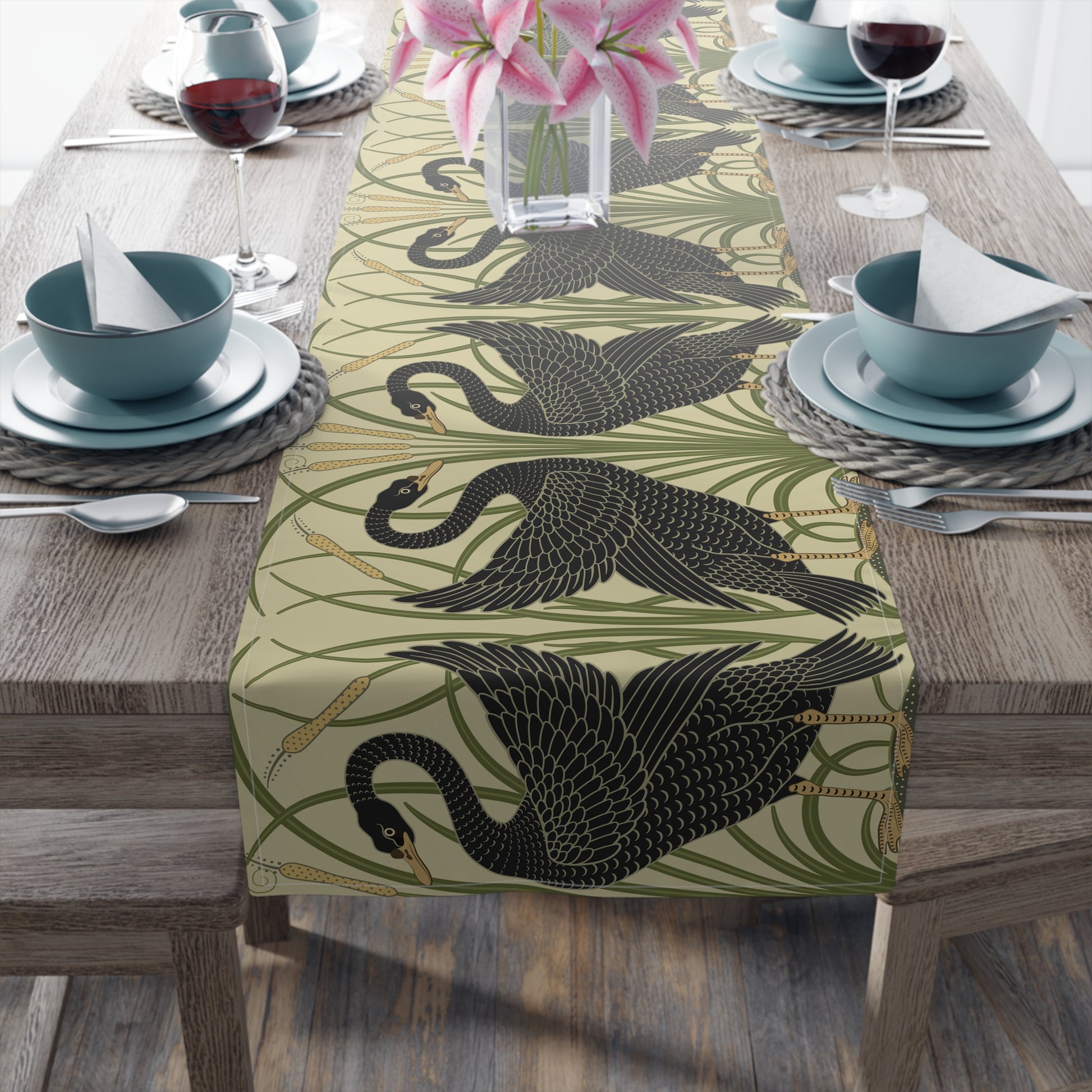 Table setting with a decorative table runner inspired by William Morris & Co featuring black swans on a tan coloured background.