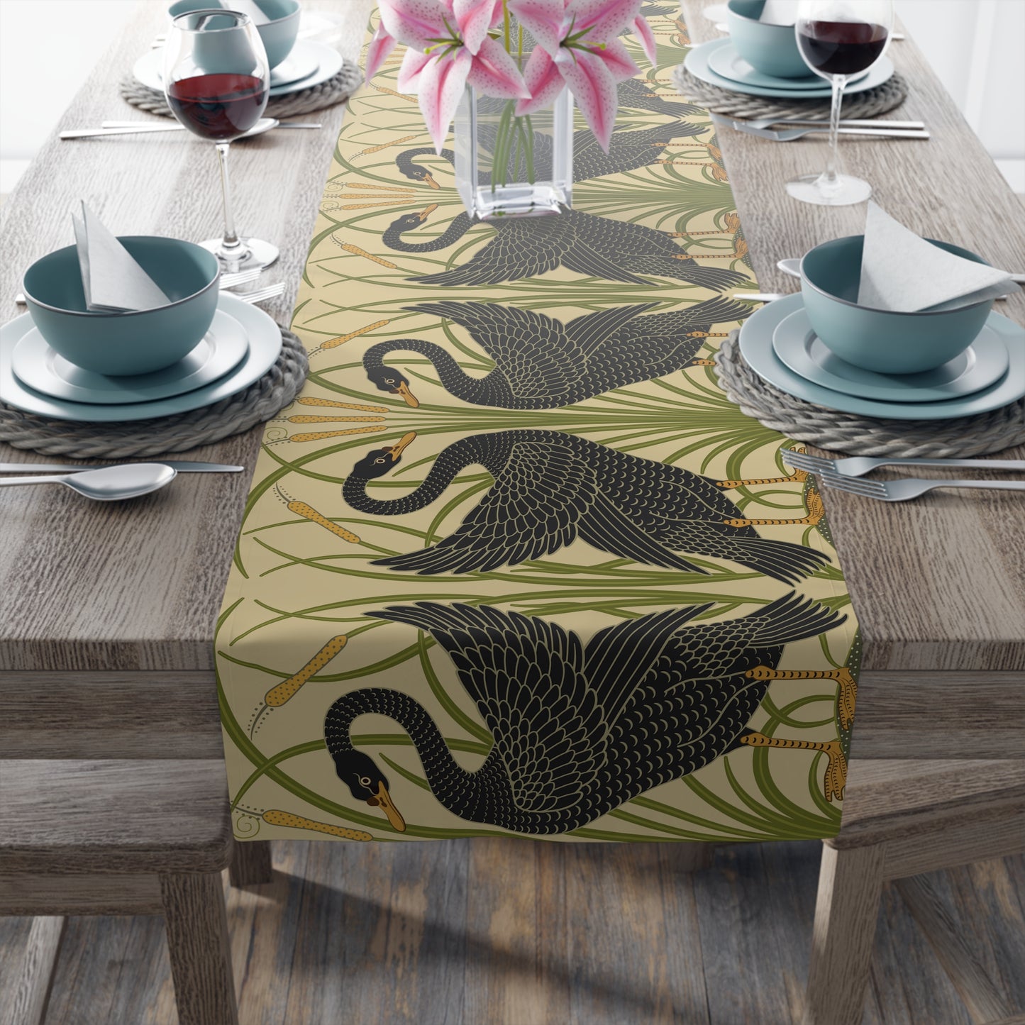Table setting with a decorative table runner inspired by William Morris & Co featuring black swans on a tan coloured background.