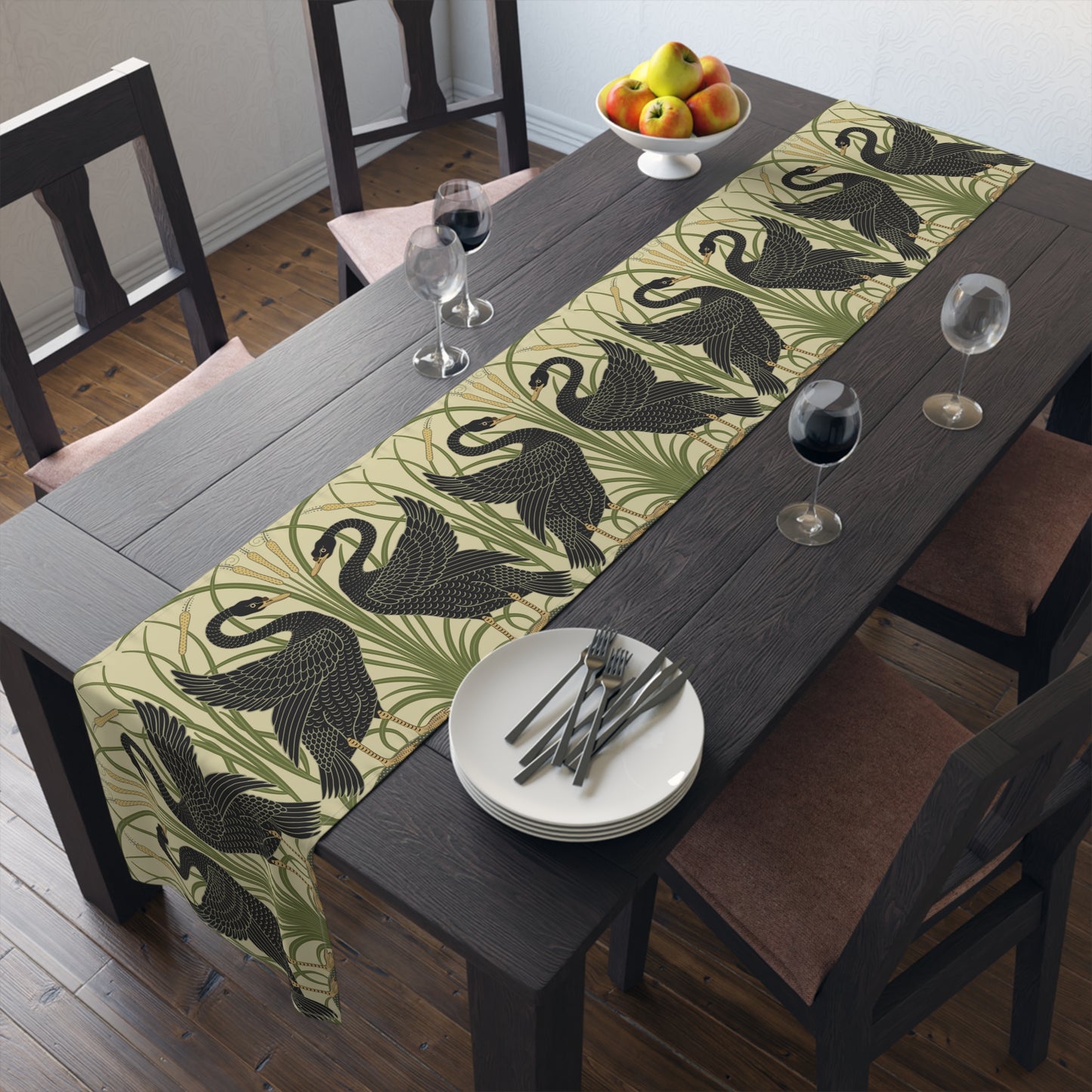 Table setting with a decorative table runner inspired by William Morris & Co featuring black swans on a tan coloured background.