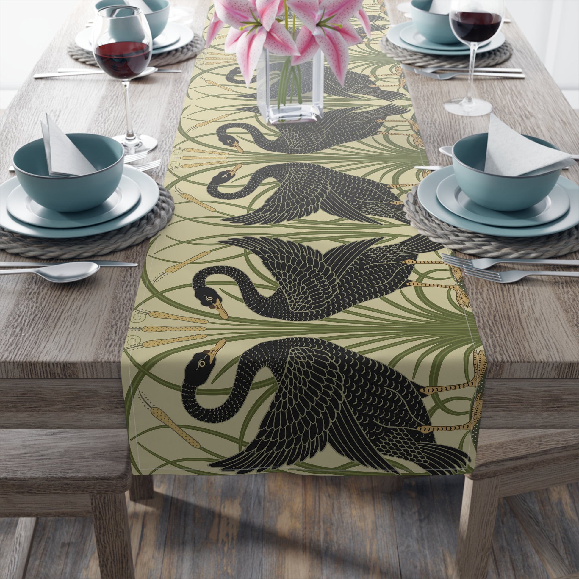 Table setting with a decorative table runner inspired by William Morris & Co featuring black swans on a tan coloured background.