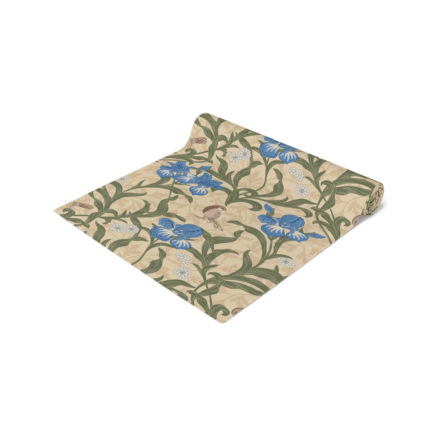 A table runner with a Victorian floral design in blue and green on a beige background, laid out on a dining table with place settings and decorative flowers.
