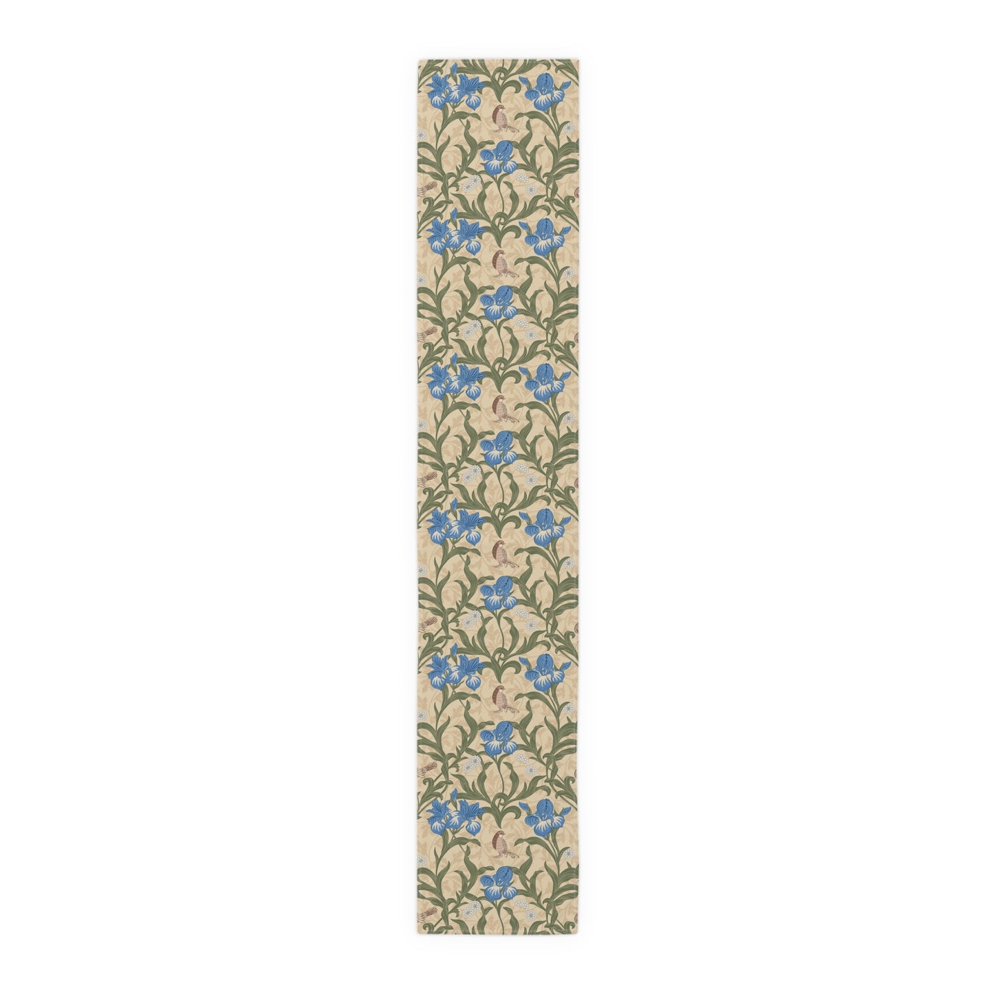 A table runner with a Victorian floral design in blue and green on a beige background, laid out on a dining table with place settings and decorative flowers.