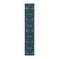 A William Morris & Co table runner with a bluebird design laid out on a dining table, featuring a repeating pattern with birds and foliage.