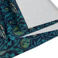 A William Morris & Co table runner with a bluebird design laid out on a dining table, featuring a repeating pattern with birds and foliage.