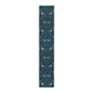 A William Morris & Co table runner with a bluebird design laid out on a dining table, featuring a repeating pattern with birds and foliage.