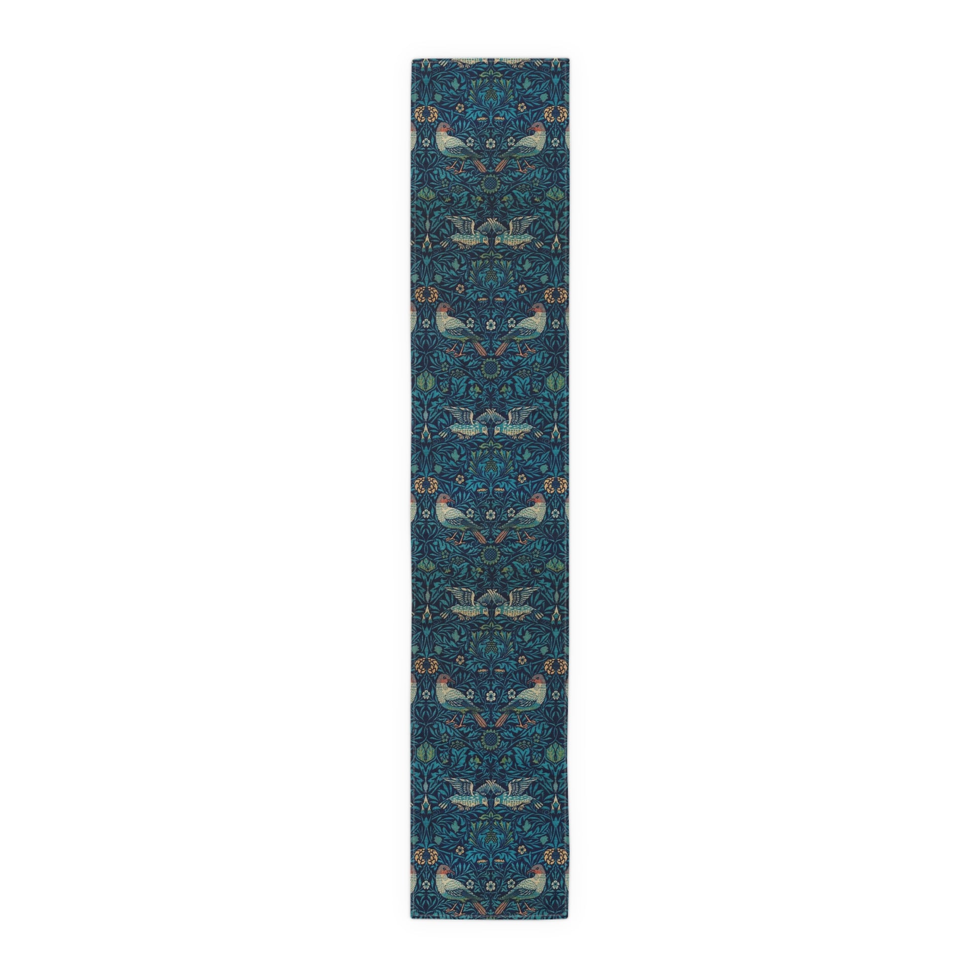 A William Morris & Co table runner with a bluebird design laid out on a dining table, featuring a repeating pattern with birds and foliage.
