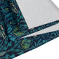 A William Morris & Co table runner with a bluebird design laid out on a dining table, featuring a repeating pattern with birds and foliage.