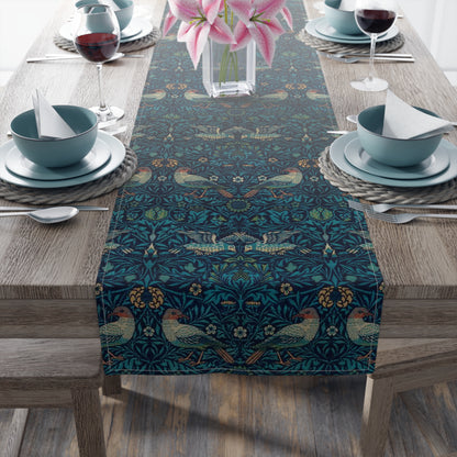 A William Morris & Co table runner with a bluebird design laid out on a dining table, featuring a repeating pattern with birds and foliage.