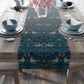 A William Morris & Co table runner with a bluebird design laid out on a dining table, featuring a repeating pattern with birds and foliage.