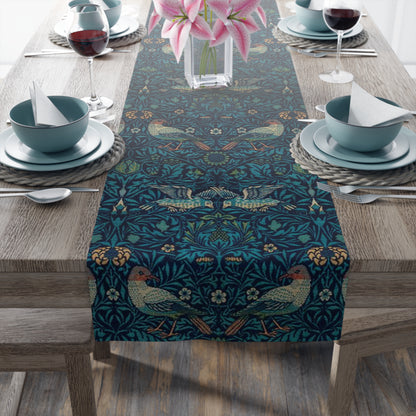 A William Morris & Co table runner with a bluebird design laid out on a dining table, featuring a repeating pattern with birds and foliage.