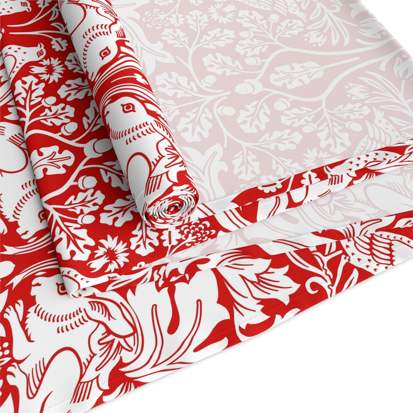 Red and white patterned fabric with floral and animal designs on a white background