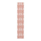 Long, narrow decorative mat with a floral pattern on a white background