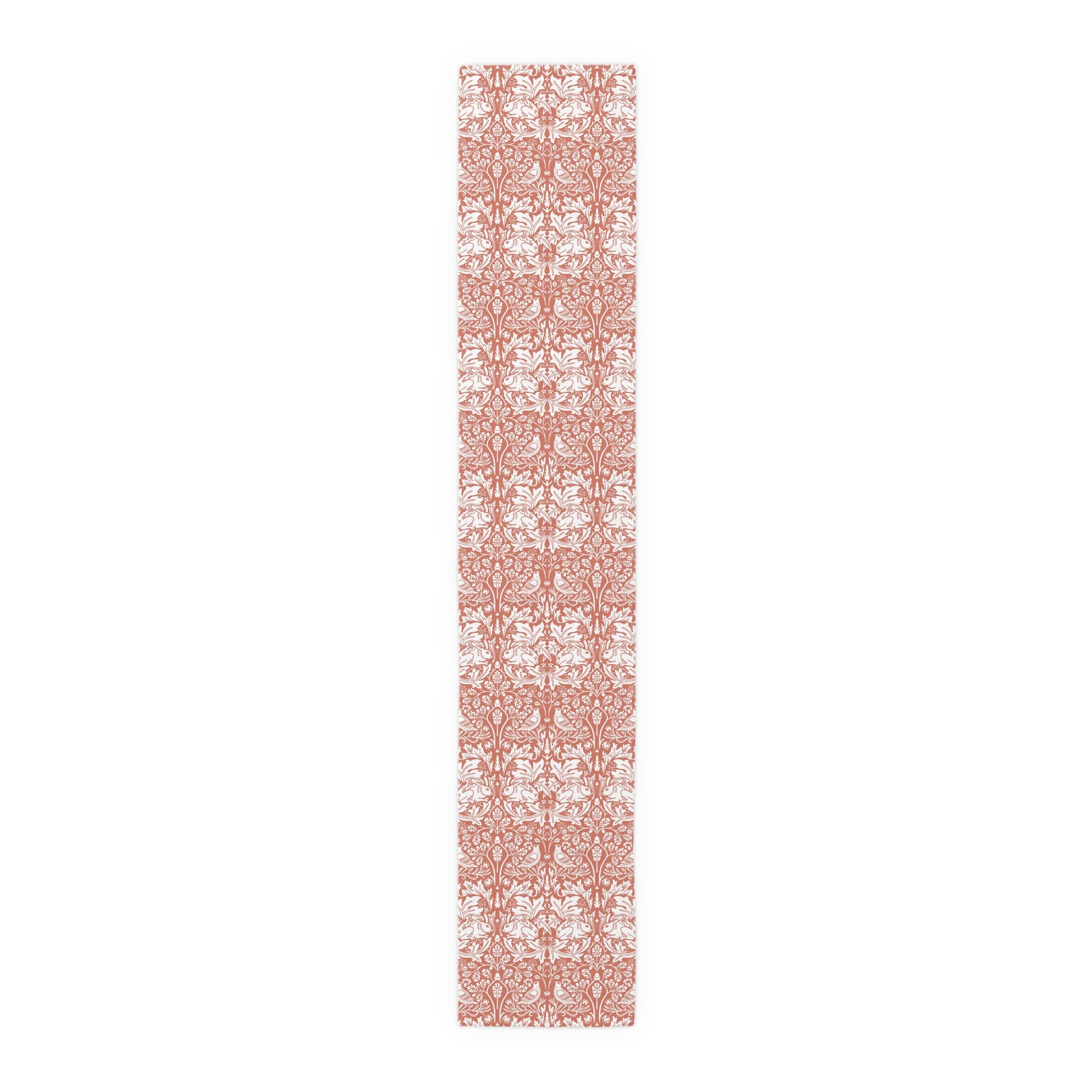 Long, narrow decorative mat with a floral pattern on a white background