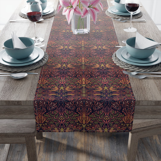 A multicolored table runner with a floral and animal pattern displayed on a dining table.