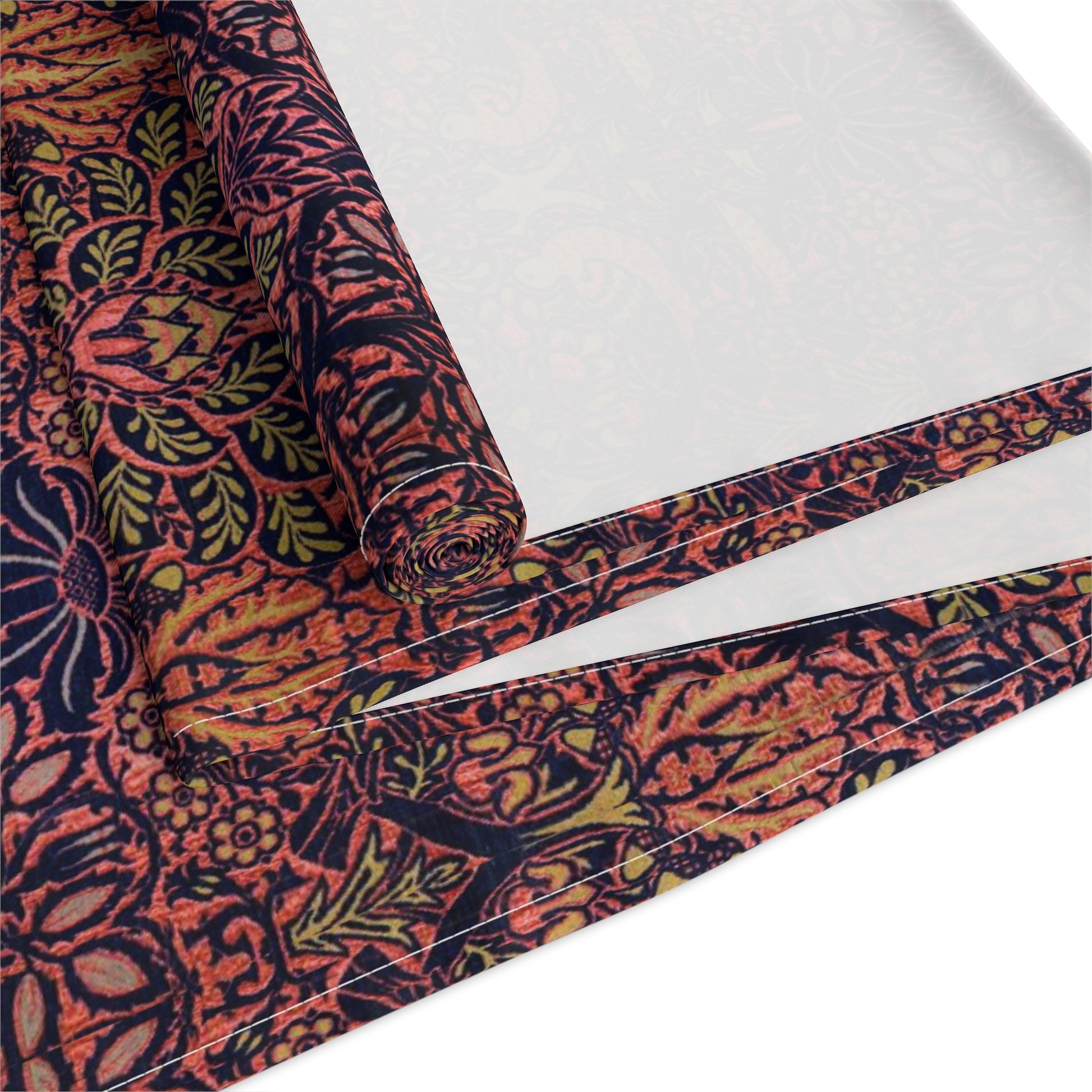 A multicolored table runner with a floral and William Morris & Co animal pattern displayed on a dining table.