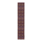 A multicolored table runner with a floral and William Morris & Co animal pattern displayed on a dining table.