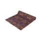 A multicolored table runner with a floral and William Morris & Co animal pattern displayed on a dining table.