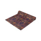 A multicolored table runner with a floral and William Morris & Co animal pattern displayed on a dining table.