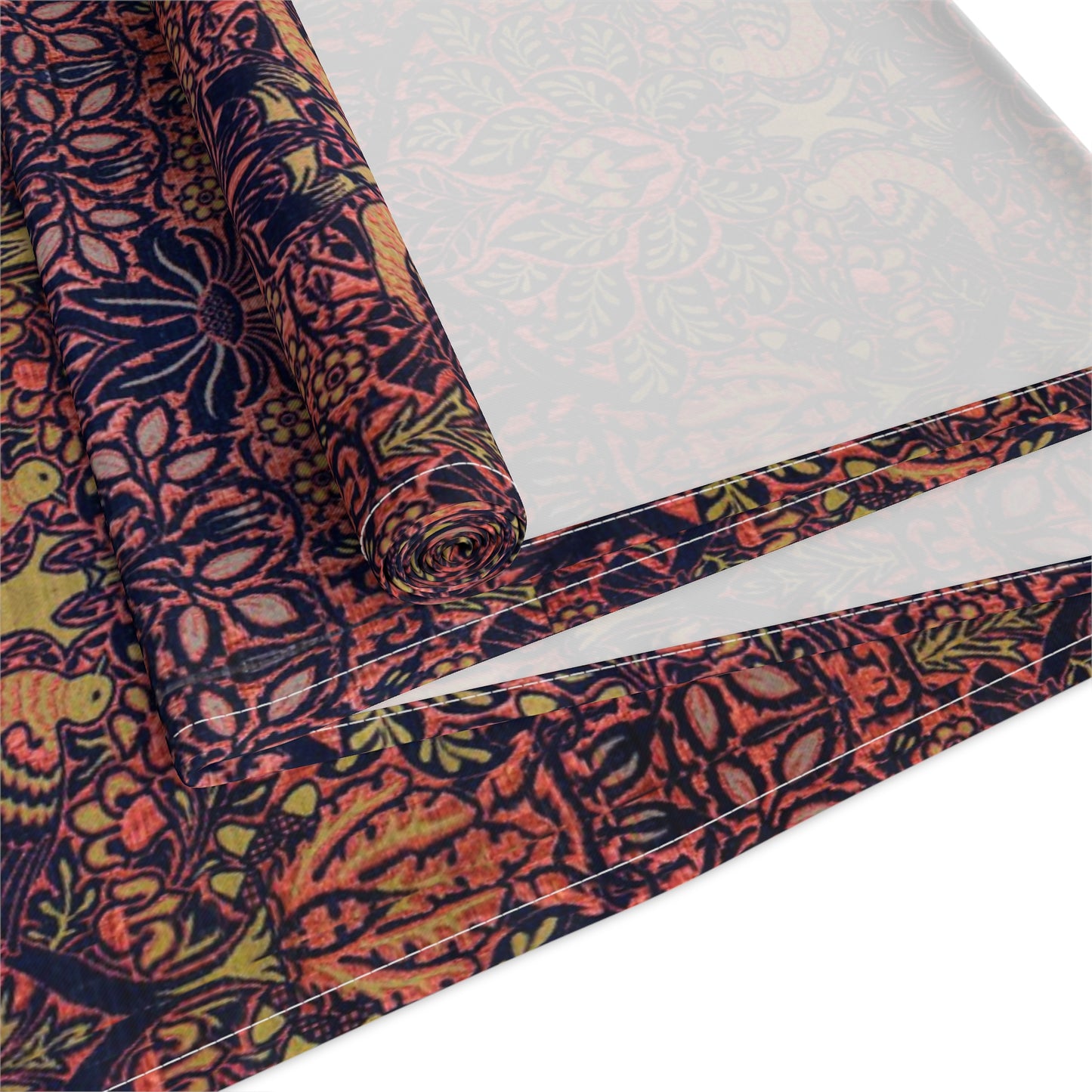 A multicolored table runner with a floral and William Morris & Co animal pattern displayed on a dining table.