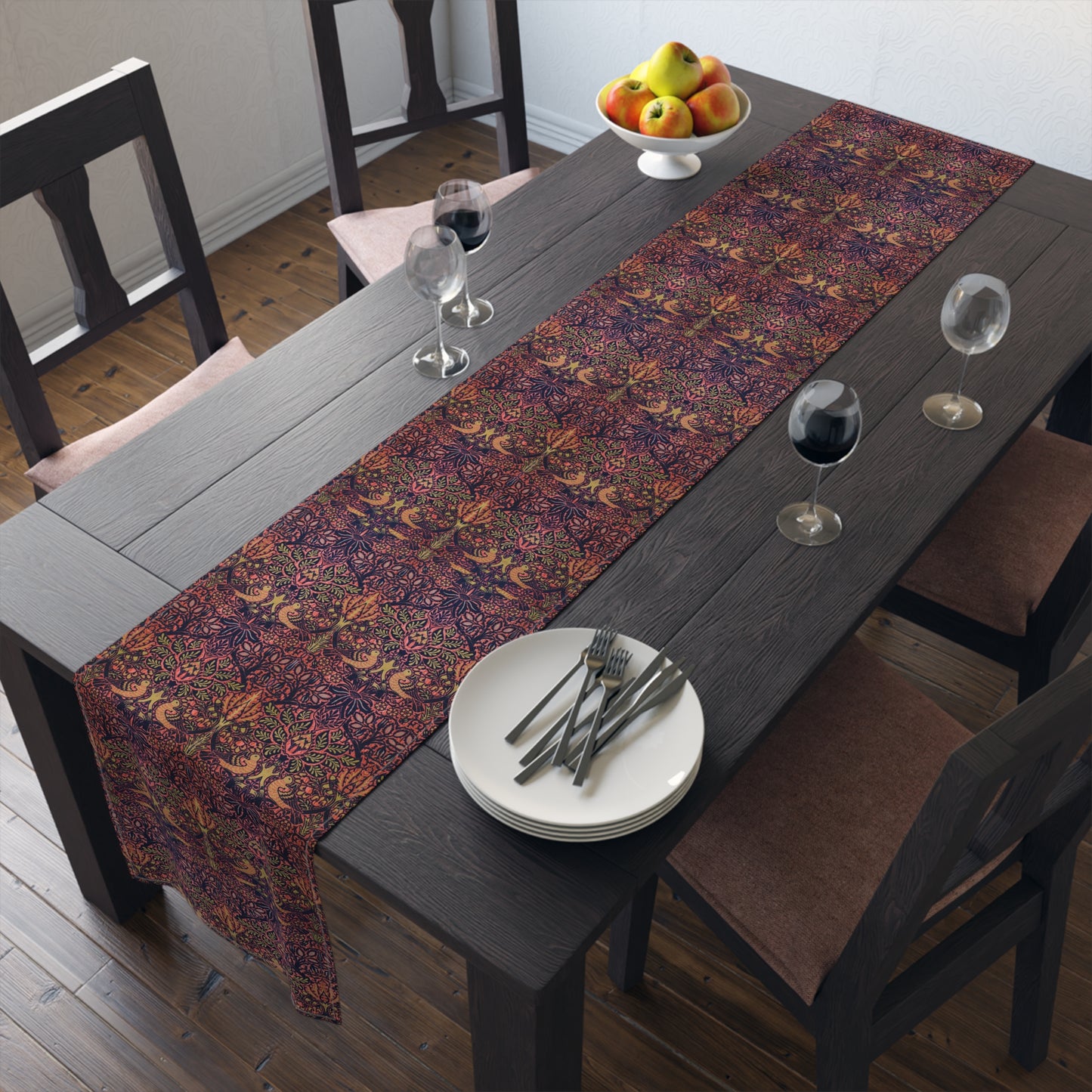 A multicolored table runner with a floral and William Morris & Co animal pattern displayed on a dining table.