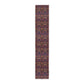 A multicolored table runner with a floral and William Morris & Co animal pattern displayed on a dining table.