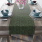 A green table runner with a floral William Morris & Co pattern displayed on a dining table.