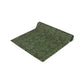 A green table runner with a floral William Morris & Co pattern displayed on a dining table.