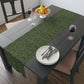 A green table runner with a floral William Morris & Co pattern displayed on a dining table.