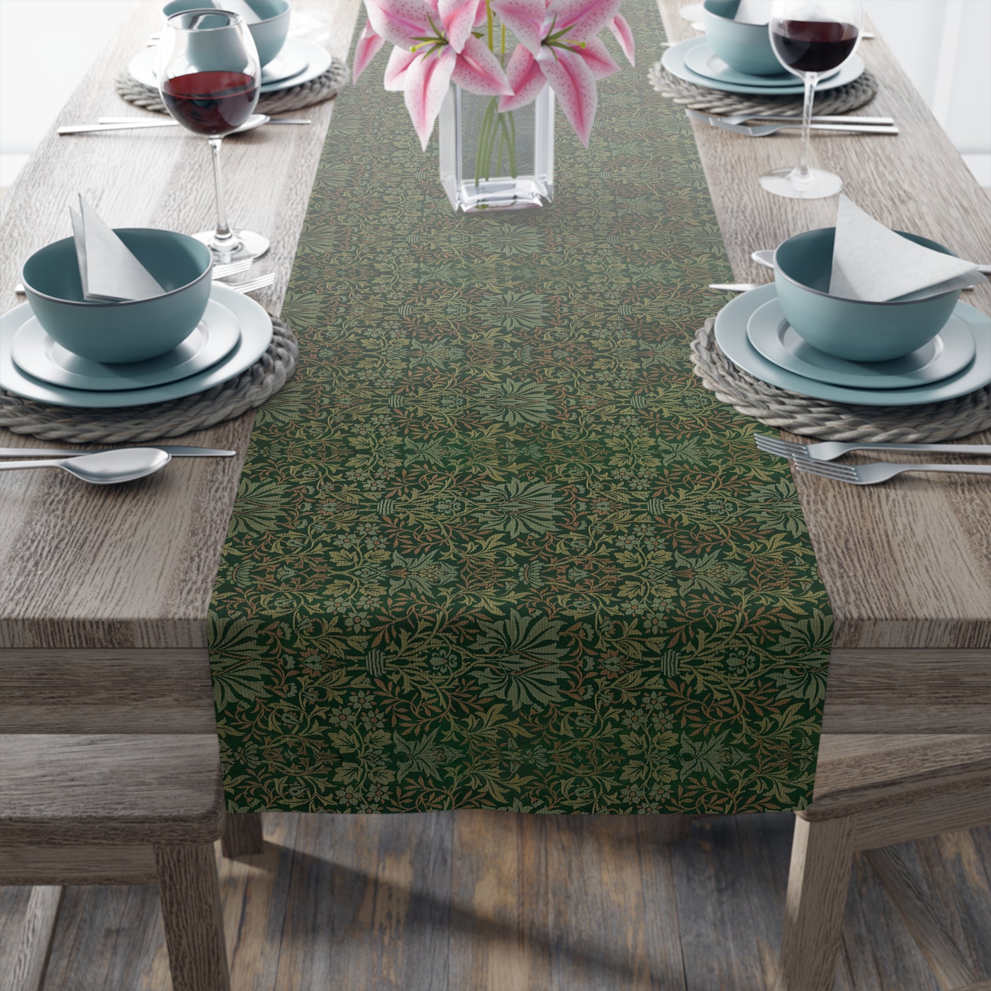 A green table runner with a floral William Morris & Co pattern displayed on a dining table.