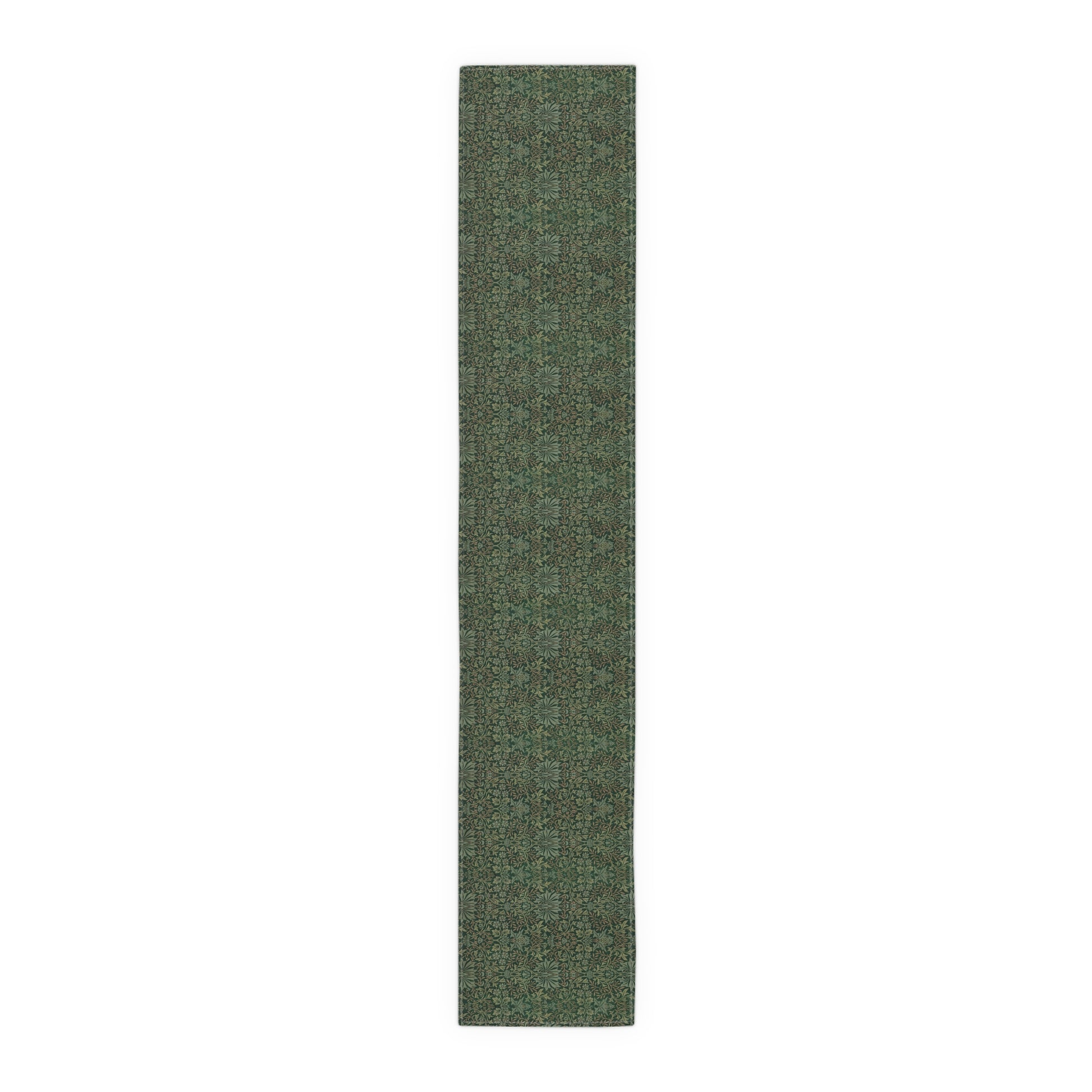 A green table runner with a floral William Morris & Co pattern displayed on a dining table.