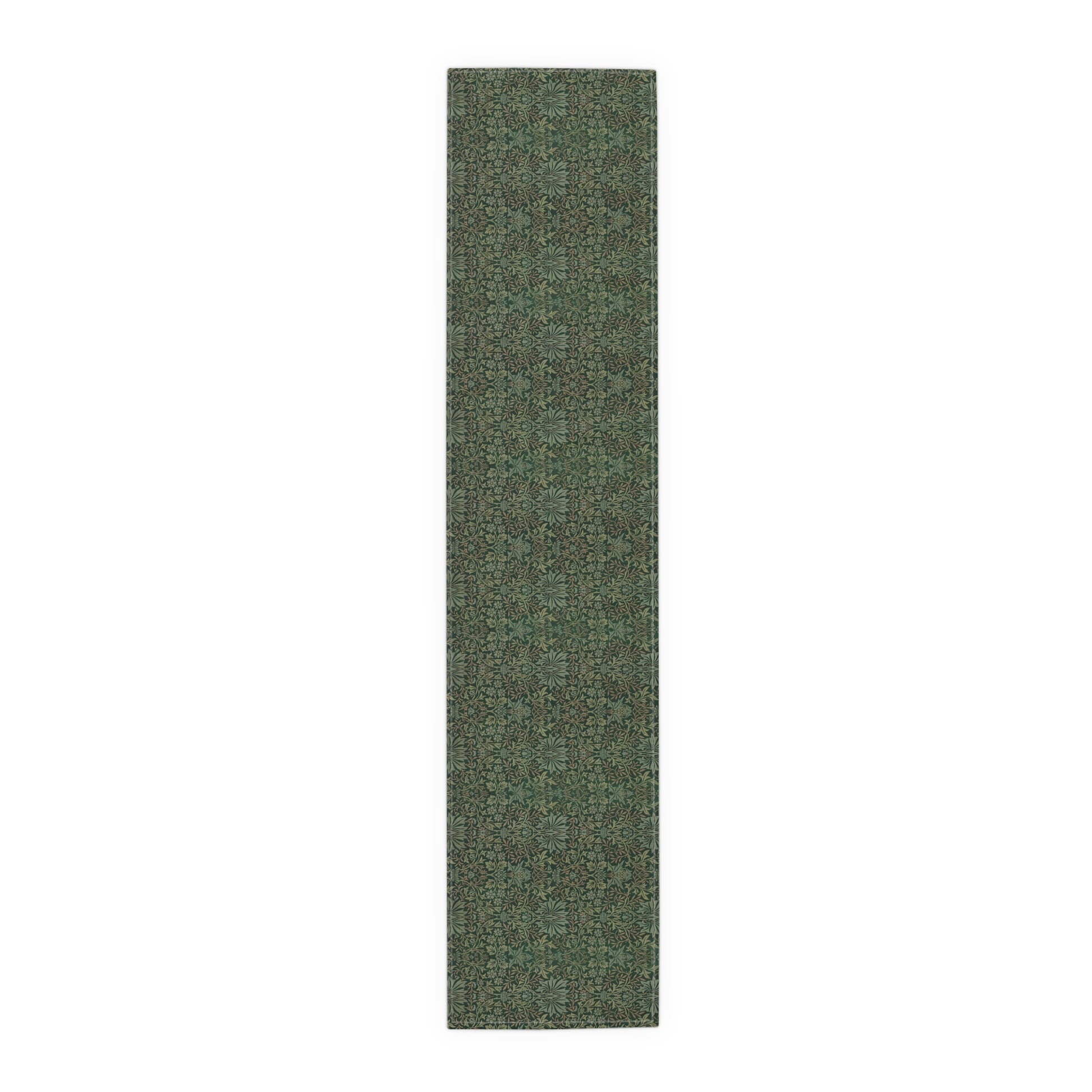 A green table runner with a floral William Morris & Co pattern displayed on a dining table.