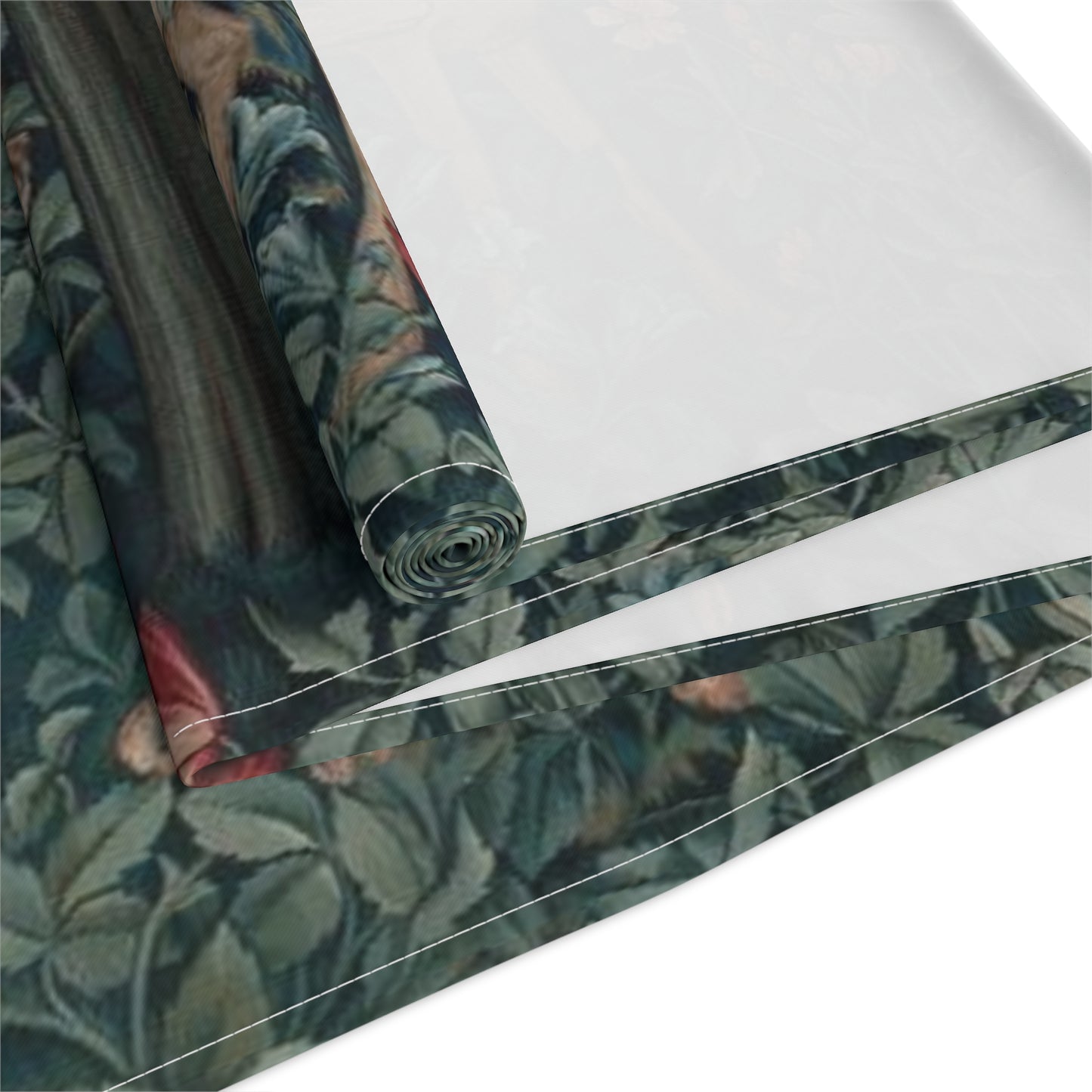 A table runner with a floral William Morris & Co pattern, featuring green leaves and pink flowers with a fox, dear and rabbit.